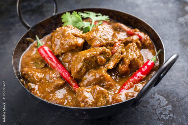 Traditional Indian curry lamb masala as close-up in a Korai